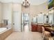 A bathroom with granite countertops, dual sinks, and a chandelier, offering a luxurious and well-lit space at 10411 Hart Branch Cir, Orlando, FL 32832