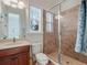 Bathroom with a glass-enclosed shower, a toilet, and a sink with granite countertops and a dark wood vanity at 10411 Hart Branch Cir, Orlando, FL 32832