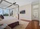 An expansive bedroom showcasing a four-poster bed and lots of natural light streaming through large windows at 10411 Hart Branch Cir, Orlando, FL 32832