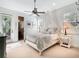 A bright bedroom with a ceiling fan, an ensuite bathroom, and lots of natural light from multiple windows at 10411 Hart Branch Cir, Orlando, FL 32832