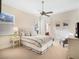 Cozy bedroom featuring a ceiling fan, neutral color palette, and plentiful natural light from the window at 10411 Hart Branch Cir, Orlando, FL 32832