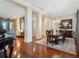 Open-concept dining area with detailed trim work, hardwood floors, and elegant chandelier at 10411 Hart Branch Cir, Orlando, FL 32832