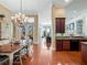 Dining area with chandelier and view of the open floor plan with kitchen and living areas at 10411 Hart Branch Cir, Orlando, FL 32832