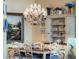 Elegant dining room with chandelier, table and chairs, hutch and wall art at 10411 Hart Branch Cir, Orlando, FL 32832
