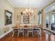 Dining room with chandelier, wood floors, and hutch for china and linens at 10411 Hart Branch Cir, Orlando, FL 32832