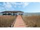 Picturesque dock leading to a waterfront property with a covered boat lift and stunning water views at 10411 Hart Branch Cir, Orlando, FL 32832