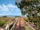 Long private dock leading to a boathouse on a serene lake under a clear sky at 10411 Hart Branch Cir, Orlando, FL 32832