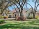 Beautiful home with a circular driveway and lush landscaping is framed by a magnificent tree canopy at 10411 Hart Branch Cir, Orlando, FL 32832