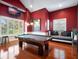 Spacious game room with pool table, window seating, and a TV for entertaining at 10411 Hart Branch Cir, Orlando, FL 32832
