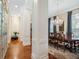 Hallway view of formal dining room with elegant chandelier and natural lighting at 10411 Hart Branch Cir, Orlando, FL 32832