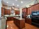 Well-equipped kitchen featuring custom cabinets, granite counters, and a center island at 10411 Hart Branch Cir, Orlando, FL 32832
