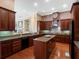 Gourmet kitchen features custom cabinetry, granite countertops and a large center island with cooktop at 10411 Hart Branch Cir, Orlando, FL 32832