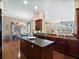 Open floor plan showing kitchen with island, dining area and living area with water view at 10411 Hart Branch Cir, Orlando, FL 32832
