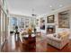 Bright and airy living room with hardwood floors and large windows overlooking the lake at 10411 Hart Branch Cir, Orlando, FL 32832