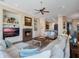 Spacious living room with a stone fireplace, plush seating, and hardwood floors at 10411 Hart Branch Cir, Orlando, FL 32832