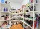 Walk-in pantry with wood floors and ample shelving for organized food and kitchen storage at 10411 Hart Branch Cir, Orlando, FL 32832