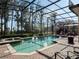 Refreshing swimming pool with a screened enclosure for privacy and relaxation, featuring a spa and lounging areas at 10411 Hart Branch Cir, Orlando, FL 32832