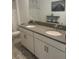 Bright bathroom featuring a double sink vanity with white cabinets and gray countertop at 11137 Lore Way, Orlando, FL 32832