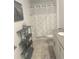 Bathroom with gray tile floors, white shower curtain, gray shelving, and sink vanity at 11137 Lore Way, Orlando, FL 32832