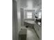 Bathroom featuring a soaking tub with tile surround, double vanity, and decorative shelving at 11137 Lore Way, Orlando, FL 32832