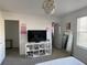 Bedroom with a TV on a shelf next to the closet doors and doorway at 11137 Lore Way, Orlando, FL 32832