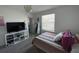 Bedroom with a bed, television on cube shelving, and a closet at 11137 Lore Way, Orlando, FL 32832
