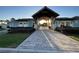 Clubhouse entrance featuring a covered walkway and lush landscaping at 11137 Lore Way, Orlando, FL 32832