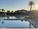 Tranquil community pool with palm trees and clear blue water, creating a relaxing atmosphere at 11137 Lore Way, Orlando, FL 32832