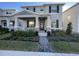 Charming two-story home featuring a welcoming front porch, manicured landscaping, and inviting curb appeal at 11137 Lore Way, Orlando, FL 32832