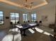 Bright game room featuring a pool table, lounge furniture, and ample natural light from large windows at 11137 Lore Way, Orlando, FL 32832