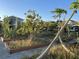 Community garden with raised garden beds filled with various plants and trees at 11137 Lore Way, Orlando, FL 32832