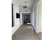 Hallway with stylish light fixtures leads to inviting spaces at 11137 Lore Way, Orlando, FL 32832