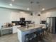 Bright kitchen with white cabinetry, a center island, and modern appliances at 11137 Lore Way, Orlando, FL 32832