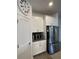 Contemporary kitchen featuring white cabinets, stainless steel refrigerator, and a practical layout for meal preparation at 11137 Lore Way, Orlando, FL 32832