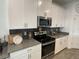Modern kitchen with stainless steel appliances, granite countertops and subway tile backsplash at 11137 Lore Way, Orlando, FL 32832