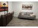 Cozy living room featuring a comfortable gray sofa and modern artwork at 11137 Lore Way, Orlando, FL 32832