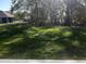 View of a large backyard with mature trees shading the green grass lawn at 12793 Sw 43Rd Cir, Ocala, FL 34473