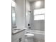 Bathroom with marble tiled shower over tub, granite countertop, and light colored floor at 12793 Sw 43Rd Cir, Ocala, FL 34473
