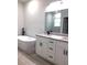 Bathroom features a modern freestanding tub, granite countertops, and a double sink vanity at 12793 Sw 43Rd Cir, Ocala, FL 34473