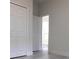 Bright bedroom featuring a closet and entry door, with neutral walls and light flooring at 12793 Sw 43Rd Cir, Ocala, FL 34473