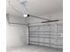 View of a standard garage door with an automatic door opener and gray metal door at 12793 Sw 43Rd Cir, Ocala, FL 34473