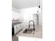 Beautiful kitchen island with a sink, stainless appliances, white cabinets, and modern pendant lighting at 12793 Sw 43Rd Cir, Ocala, FL 34473