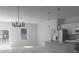 Bright, open kitchen and dining area featuring stainless steel appliances and modern light fixtures at 12793 Sw 43Rd Cir, Ocala, FL 34473