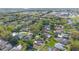 Aerial view of a property in a neighborhood with lush trees and well-maintained landscaping, showing the surrounding community at 1306 Pleasantridge Pl, Orlando, FL 32835