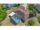 Aerial view of a home with a private screened-in pool, lush landscaping, and a spacious backyard at 1306 Pleasantridge Pl, Orlando, FL 32835