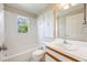 Bright bathroom featuring tile floor, white tiling in bath and shower area, and built in storage at 1306 Pleasantridge Pl, Orlando, FL 32835