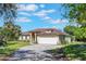 Charming single-story home with a well-manicured lawn, inviting curb appeal, and an attached two-car garage at 1306 Pleasantridge Pl, Orlando, FL 32835