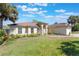 Charming single-story home with a well-manicured lawn, mature trees, and a welcoming entrance at 1306 Pleasantridge Pl, Orlando, FL 32835