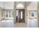Elegant foyer with decorative glass front door and sidelights, plus tile flooring and natural light at 1306 Pleasantridge Pl, Orlando, FL 32835