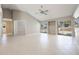 Open-concept living room with tile flooring, high ceilings, and sliding glass doors to the screened-in pool area at 1306 Pleasantridge Pl, Orlando, FL 32835